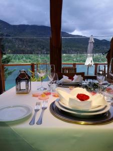 a table with a plate of food on top of it at Dos Bahias Lake Resort in Villa La Angostura
