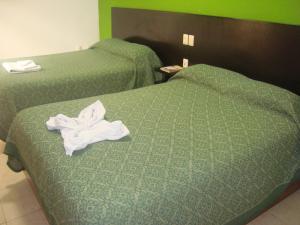 Postel nebo postele na pokoji v ubytování Hotel Real Colonial