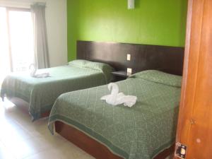 Postel nebo postele na pokoji v ubytování Hotel Real Colonial