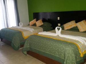 Postel nebo postele na pokoji v ubytování Hotel Real Colonial