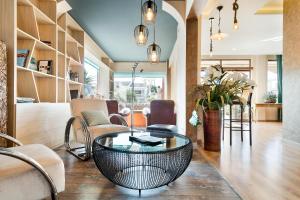 a living room with a table and chairs at Nura Santa Ponsa & Spa in Santa Ponsa