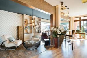 a living room with a table and chairs at Nura Santa Ponsa & Spa in Santa Ponsa