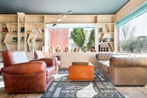 a living room with leather furniture and a window at Nura Santa Ponsa & Spa in Santa Ponsa