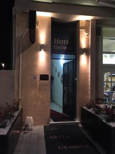 a hotel entrance with a hotel sign on the door at Hotel George in Kalamata