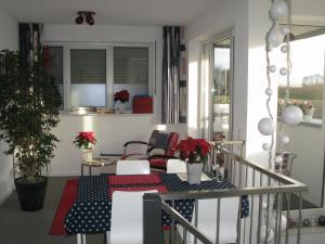 a room with a table and chairs on a balcony at B&B De Beverhoek in Roggel