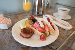 a plate of food with fruit on a table at Stafford House Bed & Breakfast in Fairfax