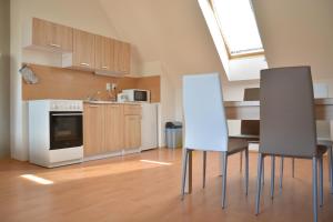 a kitchen with a table and two chairs in it at Apartmá Kateřina Velké Losiny in Velké Losiny