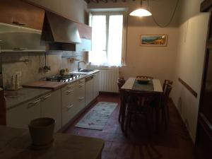 a kitchen with a table and a sink and a stove at Il Giardino in Lucca