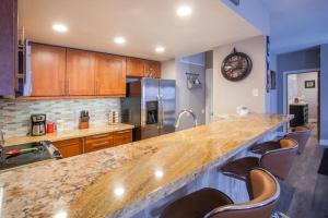 a kitchen with a large counter and some chairs at Snowcreek #881 - Phase V in Mammoth Lakes