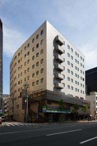 a building with a traffic light on the side of a street at HOTEL MYSTAYS Ochanomizu Conference Center in Tokyo