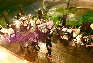 a group of people sitting at tables in a restaurant at Pousada Icaraí in Ilha Comprida