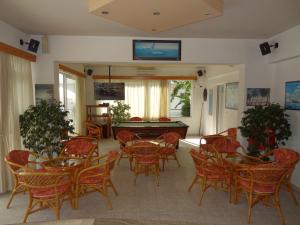 a room with tables and chairs and a pool table at Michalis Studios & Apartments in Kos Town