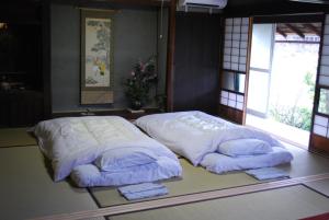 Voodi või voodid majutusasutuse Goemon Kyoto Japan toas