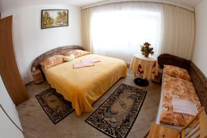 a bedroom with a bed and a large window at Penzion Macocha in Blansko