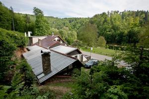 a house with a car parked in front of it at Penzion Macocha in Blansko