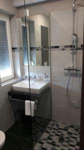 a bathroom with a sink and a shower at Sun Apartments in Mostar
