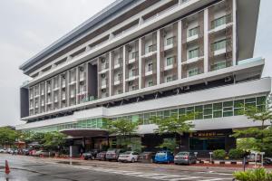 a large building with cars parked in front of it at Marvelux Hotel in Malacca