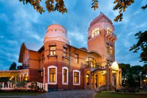 a building with an observatory on top of it at Villa Ammende Restaurant and Hotel in Pärnu
