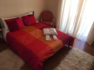 a bedroom with a colorful bed with towels on it at Apartment in Markopoulo center in Markopoulo