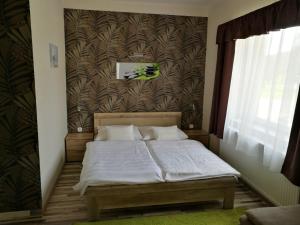 Кровать или кровати в номере Börzsöny Apartman
