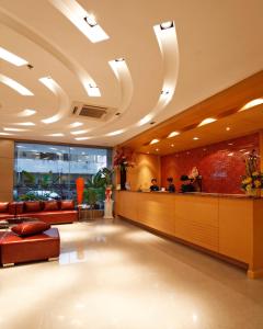 a lobby of a hotel with couches and a bar at Pattaya Loft in Pattaya Central +70 photos