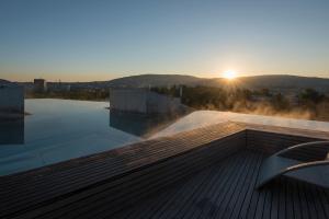 a view of the sun setting over a swimming pool at B2 Boutique Hotel Zürich in Zurich