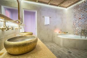 a bathroom with a large bowl sink and a tub at Ninemia Villa Zakinthos in Zakynthos Town