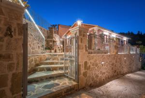 un edificio de piedra con escaleras y una puerta en Ninemia Villa Zakinthos en Zakynthos