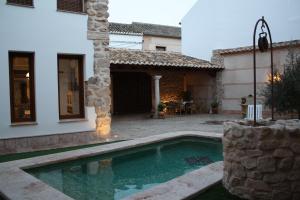 a swimming pool in the yard of a house at Casa Yedra in Almagro