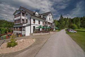 a large white building with a street in front of it at Hotel Start in Špindlerův Mlýn