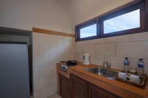 a kitchen with a sink and a window at Virmas Private Villa in Ubud