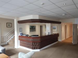 a lobby with a bar in the middle of a room at Maison Gorey Hotel in Grouville