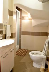 a bathroom with a toilet and a sink at Apartments Maris in Vinišće