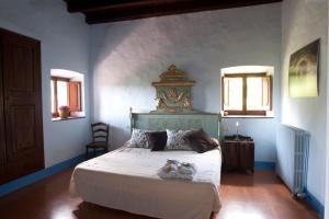a bedroom with a bed with two shoes on it at Casa Prat in Sant Feliu de Pallerols