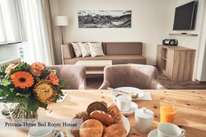 a living room with a table with food on it at Private Holiday Homes by Solaria in Davos