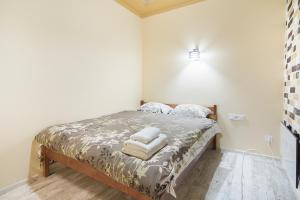 a bedroom with a bed with towels on it at Club Suite near Deribasovskaya in Odesa