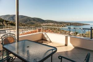 a table on a balcony with a view of the ocean at Epidavros Seascape in Ancient Epidavros