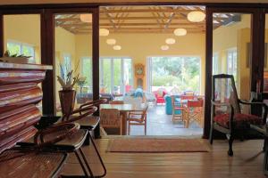 a living room with chairs and a table and a dining room at Steytlerville Villa Guest house in Steytlerville