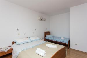 Posteľ alebo postele v izbe v ubytovaní Apartments Mira