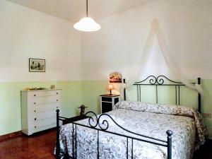 a bedroom with a bed and a dresser in it at Appartamento Borgo in Suvereto