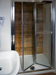 a shower with a glass door in a bathroom at Sleep'n go Hotel in Fiumicino
