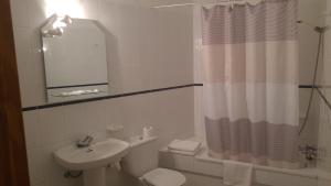 a bathroom with a sink and a toilet and a mirror at Apartamentos Martell in Playa de Santiago +16 photos