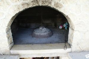 a brick oven with a large pot in it at Apartments Jurjevic in Petrcane
