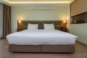 Postel nebo postele na pokoji v ubytování Numi Hotel