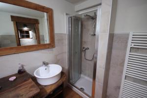 a bathroom with a sink and a shower at Vecchio Fienile in Aosta
