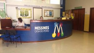 two women sitting at a reception counter at a mesneys cosmopolis office at Mussiene House - CPSBM in São Bartolomeu de Messines