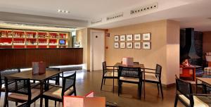 a restaurant with two tables and chairs and a bar at HG Cerler in Cerler +23 photos