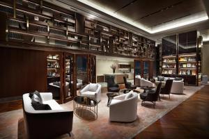 a library with couches and chairs in a room at Signiel Seoul in Seoul