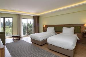 Postel nebo postele na pokoji v ubytování Numi Hotel