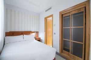 Łóżko lub łóżka w pokoju w obiekcie Petit Palace Preciados